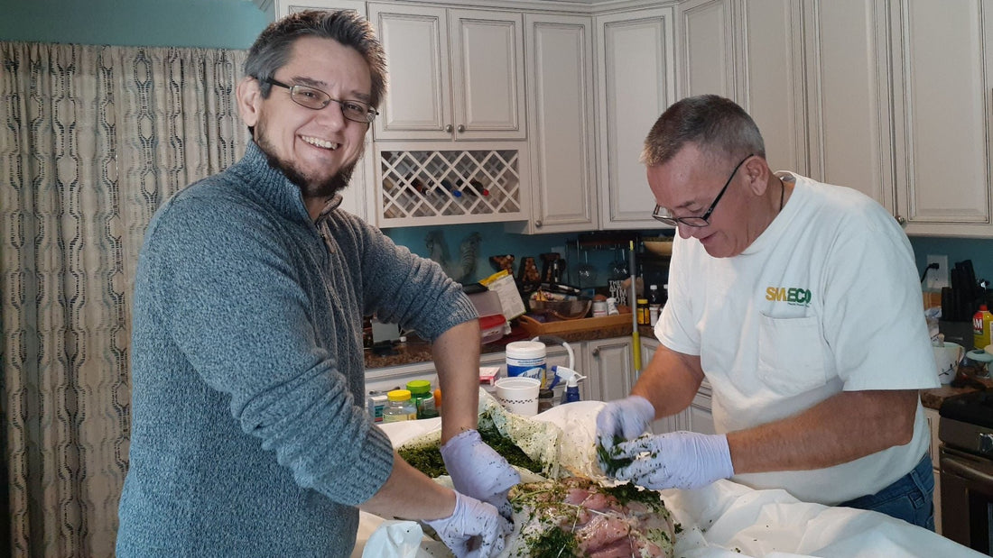 My Dad and I stuffing a ham this year.